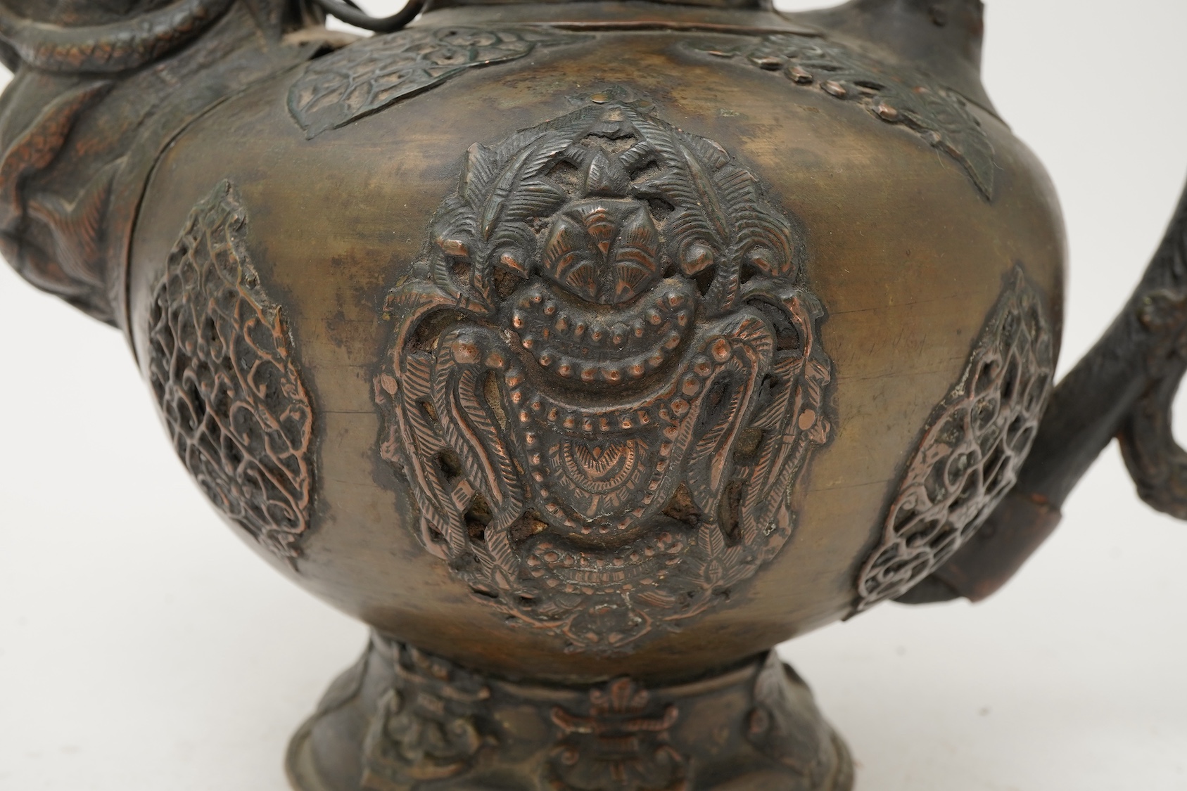 A large Tibetan repoussé brass and copper ewer, 19th century
